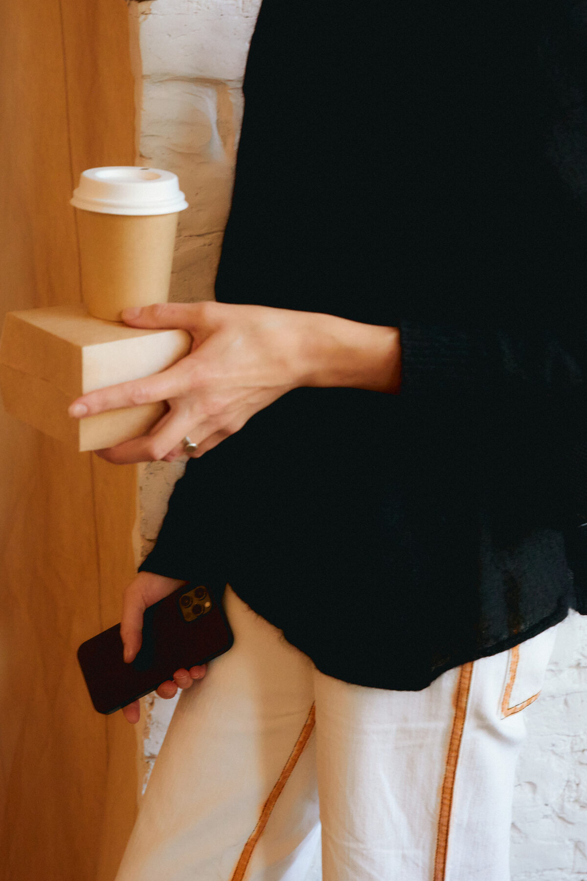 A finished latte handed across the Sigo cart to a guest