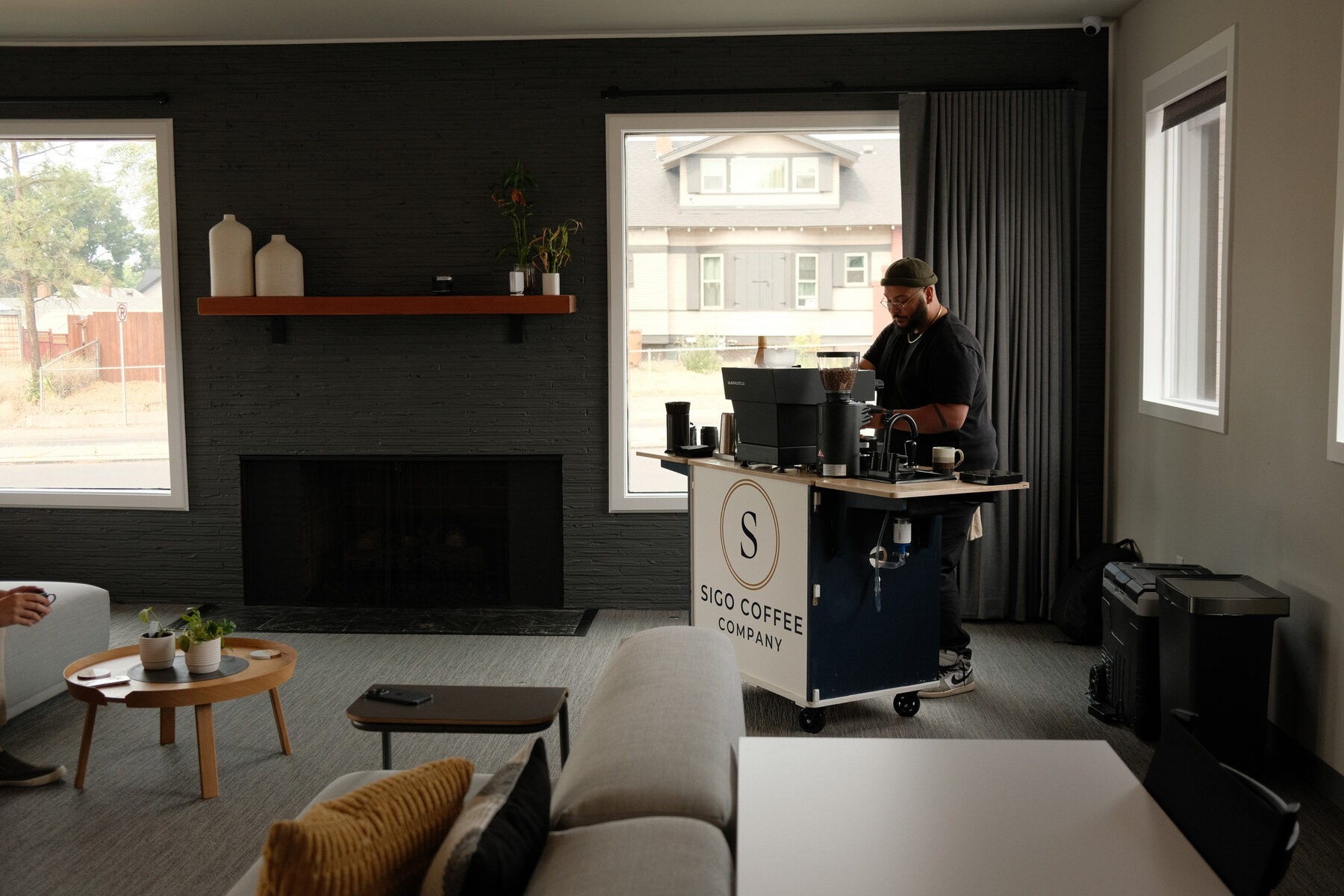 The Sigo espresso cart set up indoors in a lounge, tucked against the wall of the room