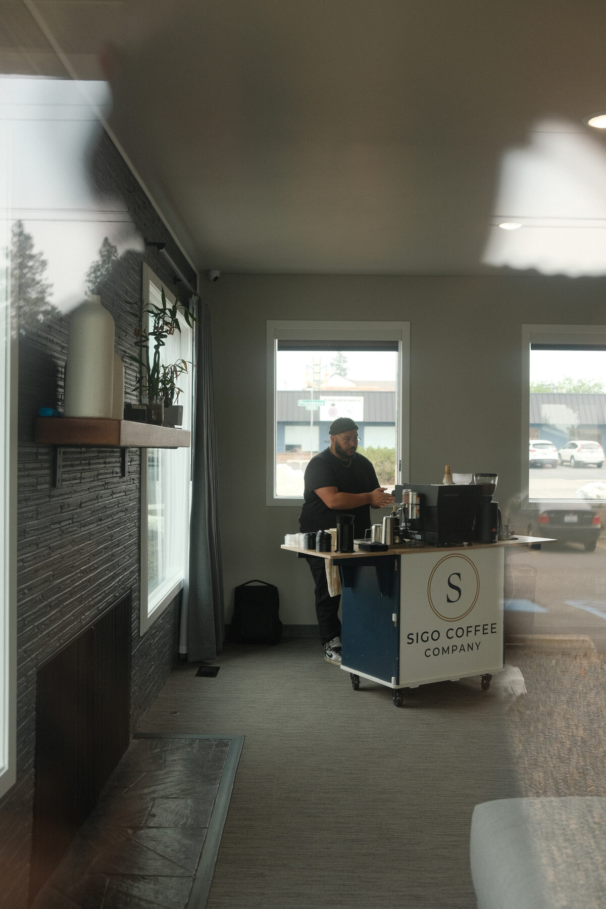 The Sigo Coffee Company cart, branded panel facing the room, mid-service